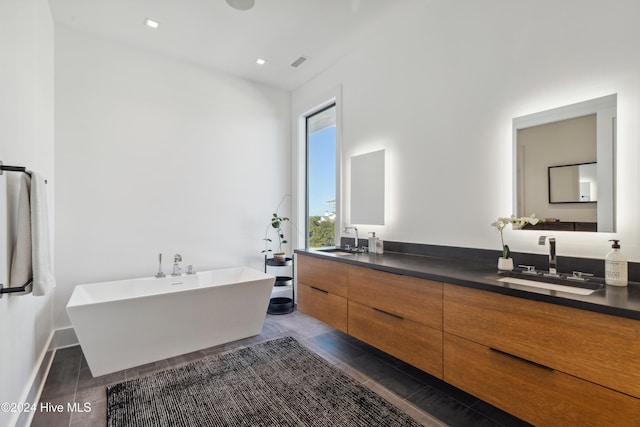 bathroom featuring vanity and a tub to relax in