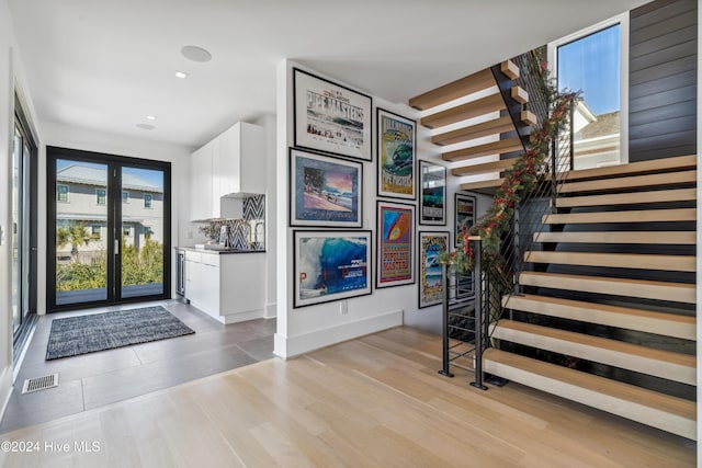 foyer featuring light wood-type flooring and a wealth of natural light