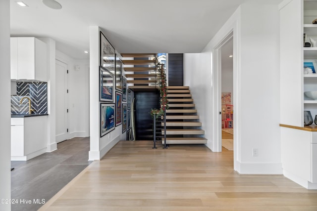 stairs featuring hardwood / wood-style flooring