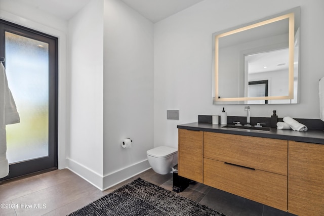 bathroom featuring vanity and toilet