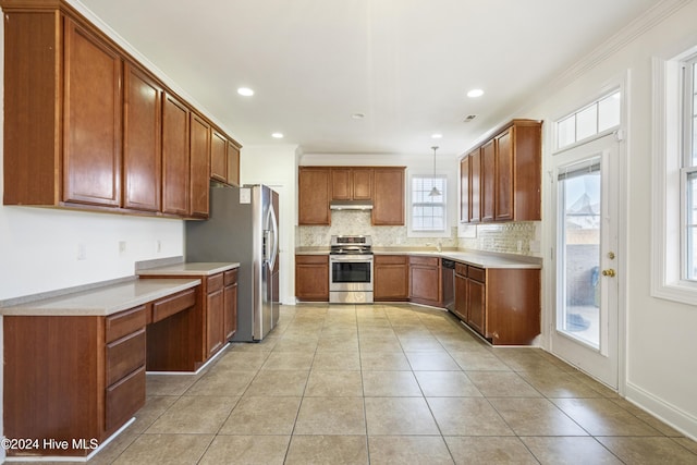 kitchen with decorative light fixtures, stainless steel appliances, plenty of natural light, and ornamental molding