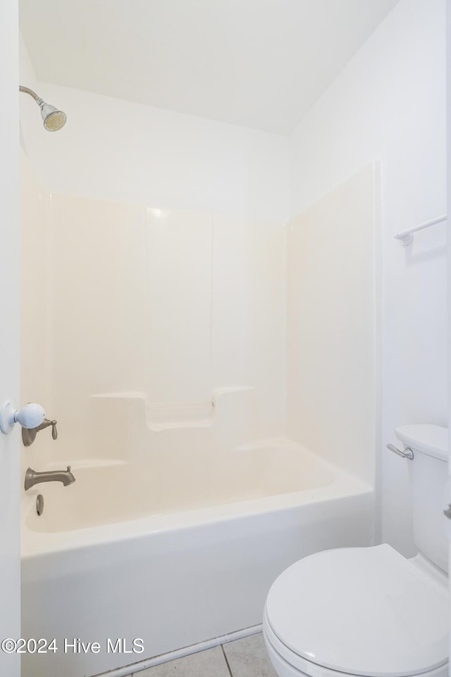 bathroom featuring toilet, shower / bath combination, and tile patterned floors