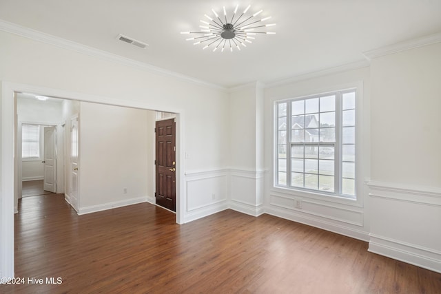 spare room with crown molding and dark hardwood / wood-style floors