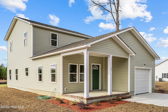 view of front of property with a porch and a garage