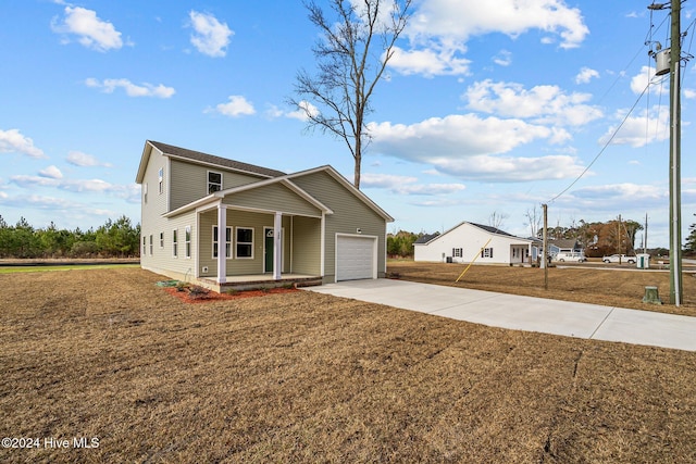 view of front of home with a porch, a garage, and a front lawn