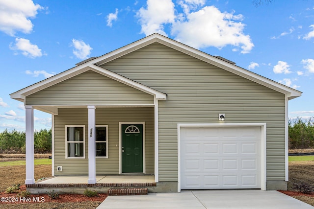 view of front facade with covered porch and a garage