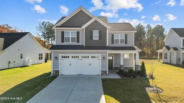 craftsman inspired home with concrete driveway, stone siding, an attached garage, a porch, and a front yard