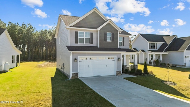 craftsman-style home featuring a garage, a front yard, and driveway