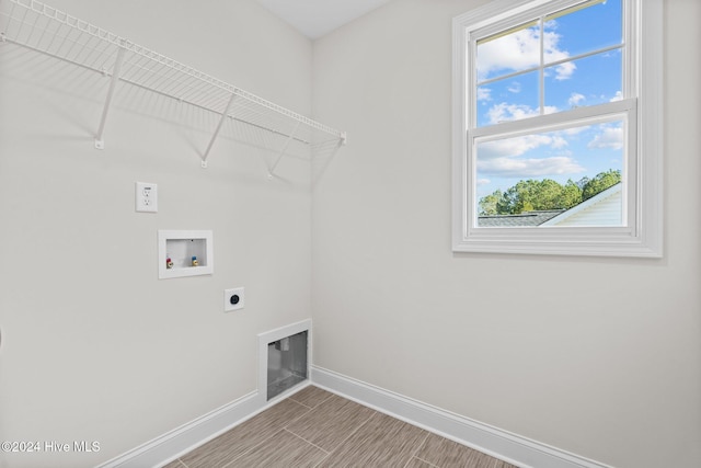 laundry room featuring baseboards, laundry area, hookup for a washing machine, and hookup for an electric dryer