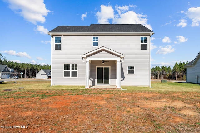 rear view of property with a yard, a patio area, and ceiling fan