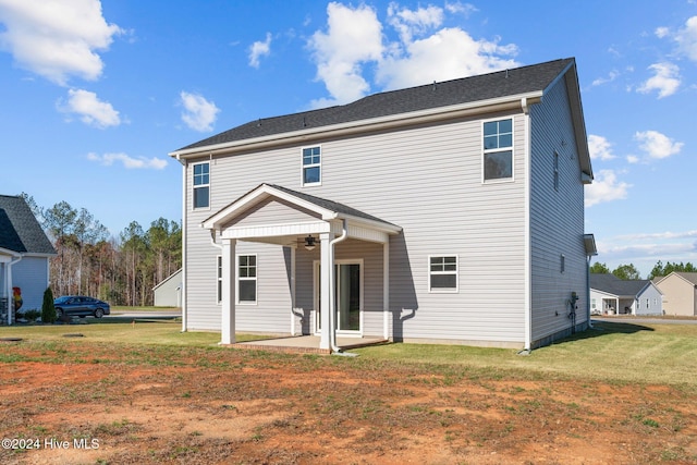 rear view of house featuring a patio area, ceiling fan, and a lawn