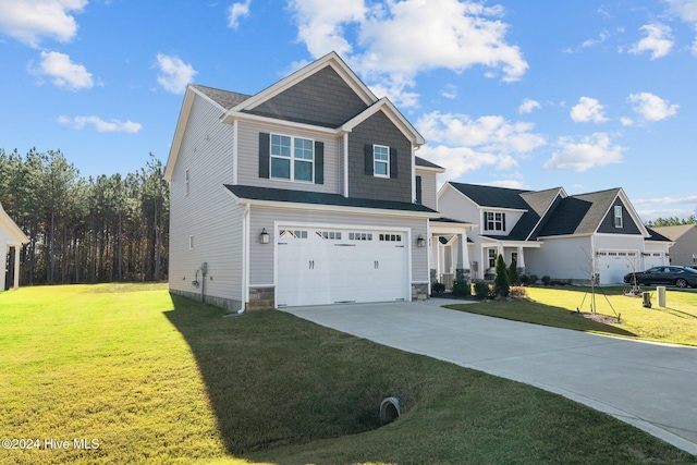 view of front of property featuring driveway, a garage, and a front lawn