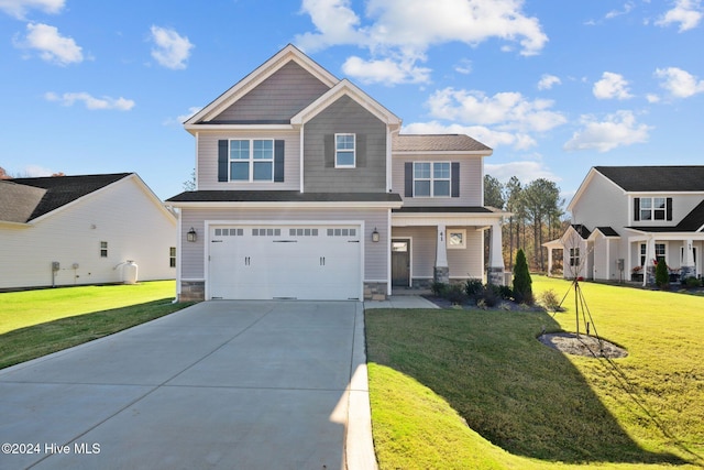 craftsman inspired home featuring driveway, stone siding, an attached garage, and a front lawn