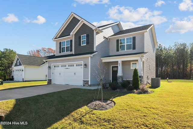 craftsman-style house with an attached garage, cooling unit, driveway, stone siding, and a front lawn