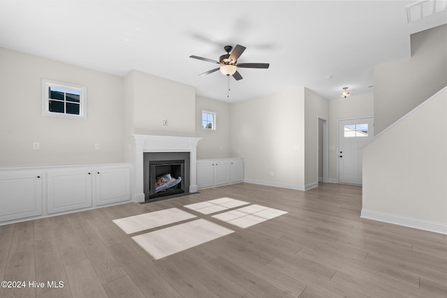 unfurnished living room featuring ceiling fan and light hardwood / wood-style floors