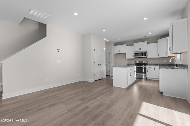 kitchen with recessed lighting, white cabinetry, visible vents, appliances with stainless steel finishes, and light wood finished floors