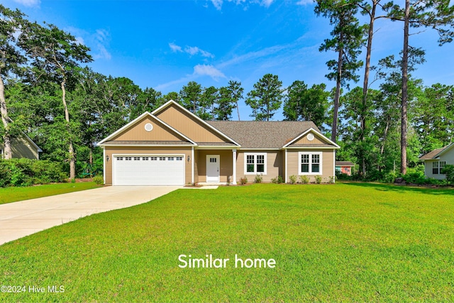 view of front of house featuring a garage and a front lawn