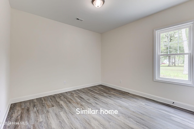 unfurnished room featuring hardwood / wood-style flooring