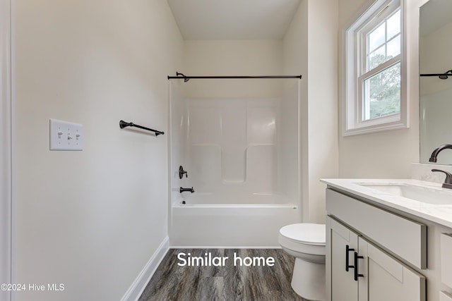 full bathroom with shower / tub combination, vanity, hardwood / wood-style flooring, and toilet