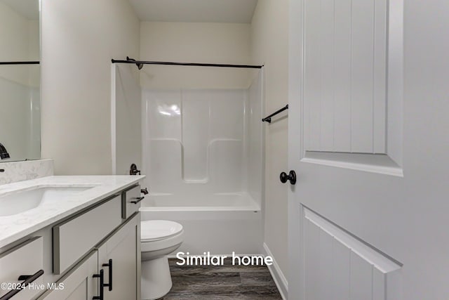 full bathroom featuring bathtub / shower combination, vanity, hardwood / wood-style flooring, and toilet