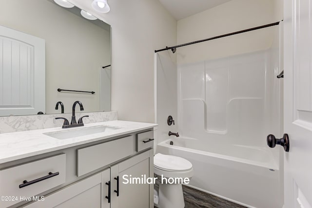 full bathroom featuring vanity, toilet, wood-type flooring, and shower / washtub combination