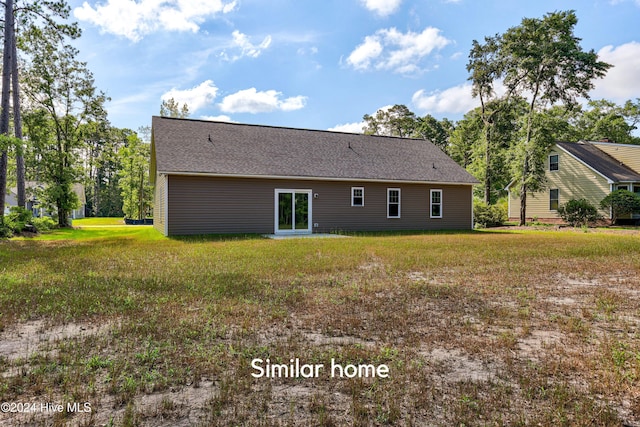 rear view of house with a yard