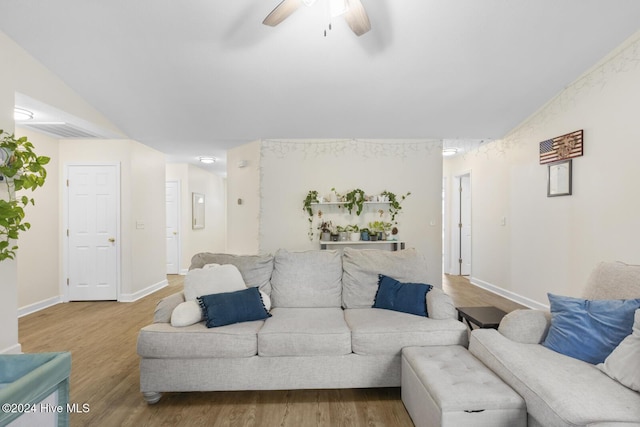 living room with light wood-type flooring, vaulted ceiling, and ceiling fan