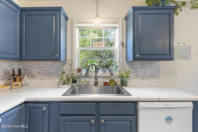 kitchen with white dishwasher, blue cabinets, and sink