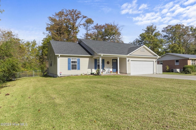 view of front of home with covered porch, a front yard, and a garage