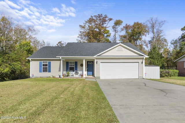 ranch-style home with covered porch, a garage, and a front lawn