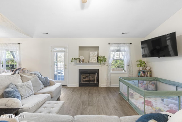 living room with light wood-type flooring and vaulted ceiling