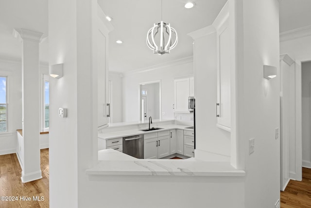 kitchen featuring sink, light hardwood / wood-style flooring, appliances with stainless steel finishes, ornamental molding, and white cabinets