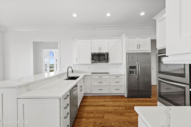 kitchen featuring dark wood-type flooring, sink, white cabinetry, and appliances with stainless steel finishes