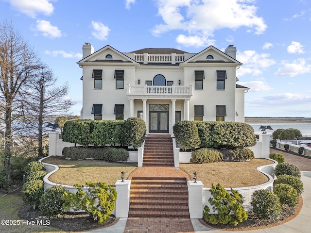 view of front of property with french doors and a balcony