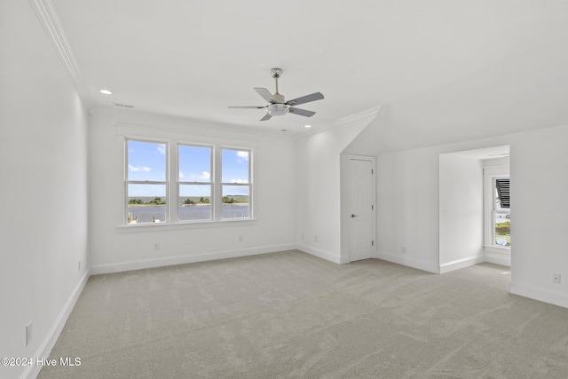 carpeted empty room with ceiling fan and crown molding