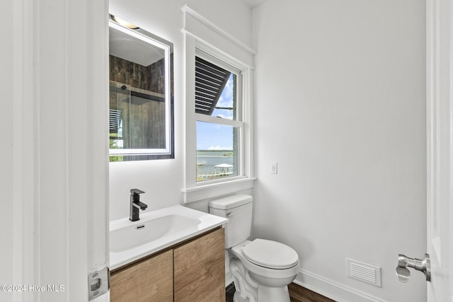 bathroom featuring toilet and vanity