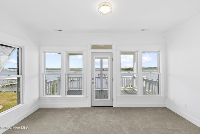 unfurnished sunroom featuring a water view