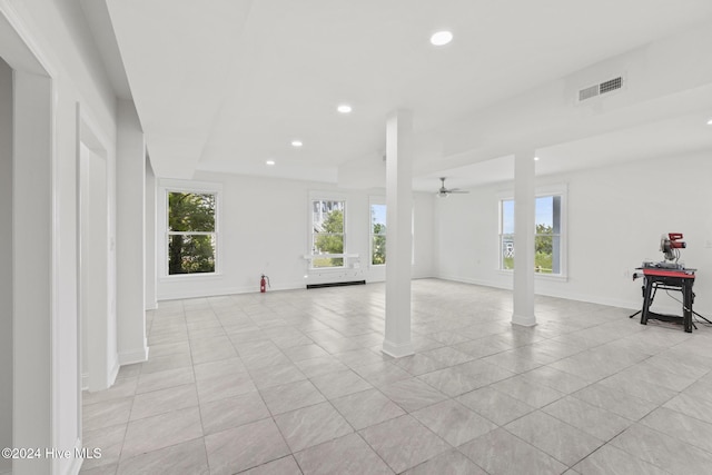 interior space featuring ceiling fan, a wealth of natural light, and light tile patterned flooring