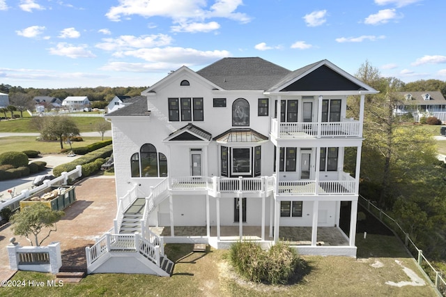 rear view of property with a balcony and a patio