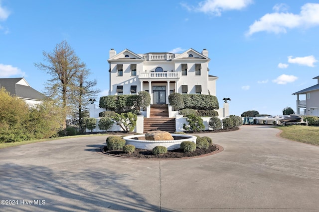 view of front of home featuring a balcony