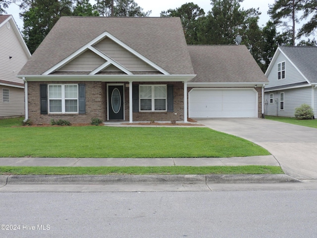 craftsman inspired home featuring a garage and a front lawn