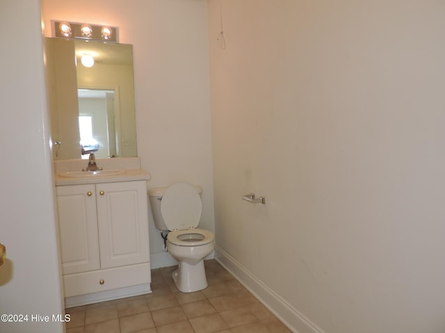 bathroom featuring tile patterned flooring, vanity, and toilet