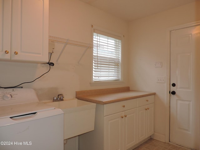 washroom featuring sink, cabinets, and washer / dryer