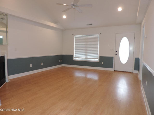 entryway with ceiling fan, light hardwood / wood-style flooring, and vaulted ceiling