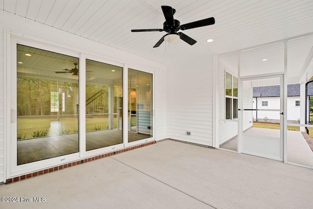 unfurnished sunroom with ceiling fan