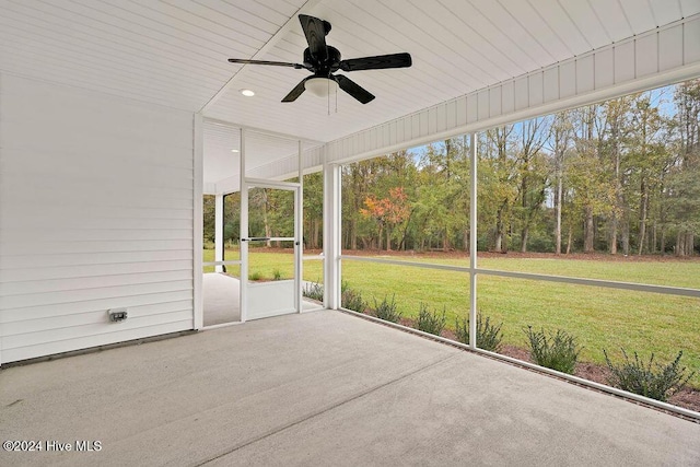 unfurnished sunroom with ceiling fan