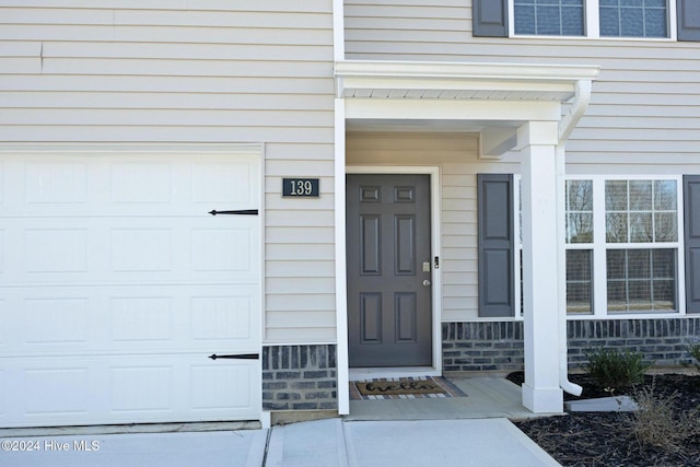 doorway to property featuring a garage