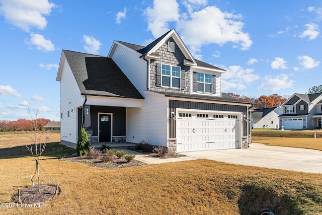 craftsman-style home featuring a garage and a front lawn