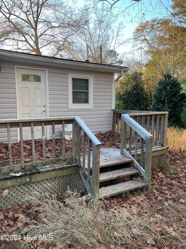 doorway to property featuring a wooden deck