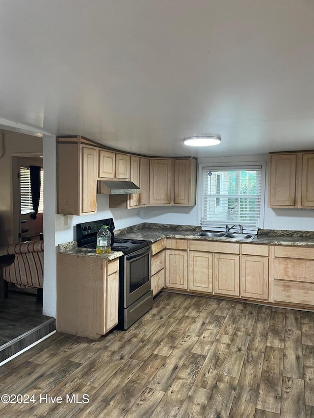kitchen with stainless steel electric stove, light brown cabinets, dark hardwood / wood-style flooring, and sink